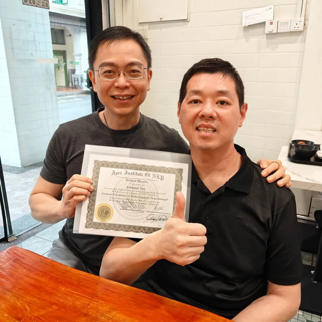Edmund Tan receiving his Licensed Practitioner of Neuro-Linguistic Programming certificate with Stuart Tan